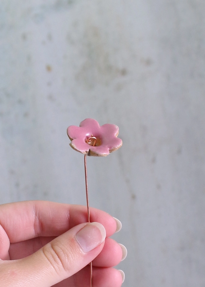 Original Ceramic Flower Decorative Bud Stems (Set of 3), hand holding our original ceramic flower stem in fuchsia with copper wire stem. 