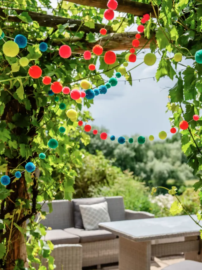 Pom Pom Garland with neon bright colours from pinks yellows green and blues