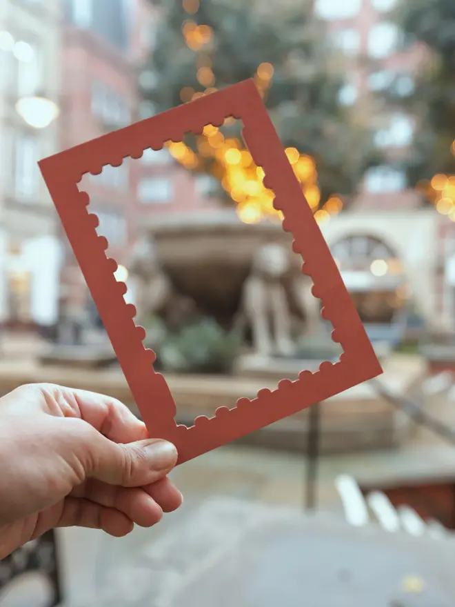 terracotta coloured stamp-shaped mount