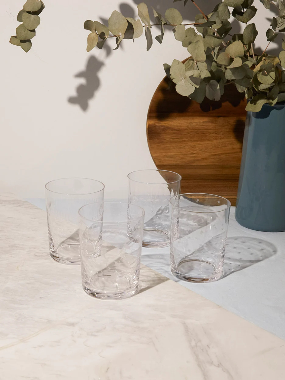 engraved stars large crystal tumblers (set of 4). four large drinks glasses patterned with small stars.