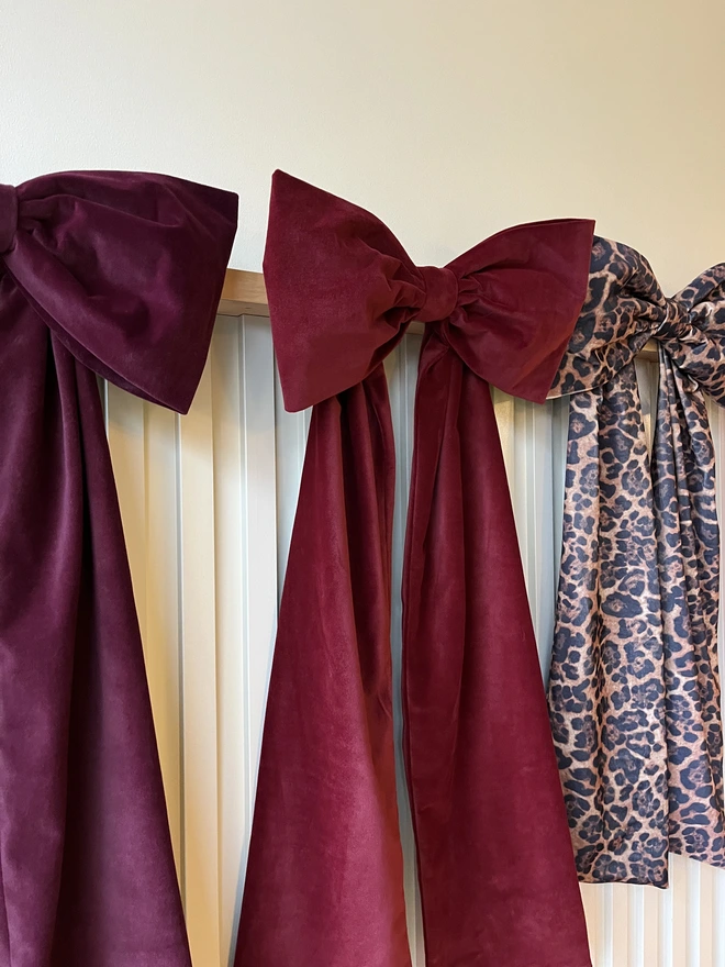 Wine Red Bow flanked by Burgundy Bow left and Leopard Print right 