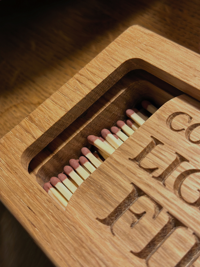 Close up of oak matchbox with long matches
