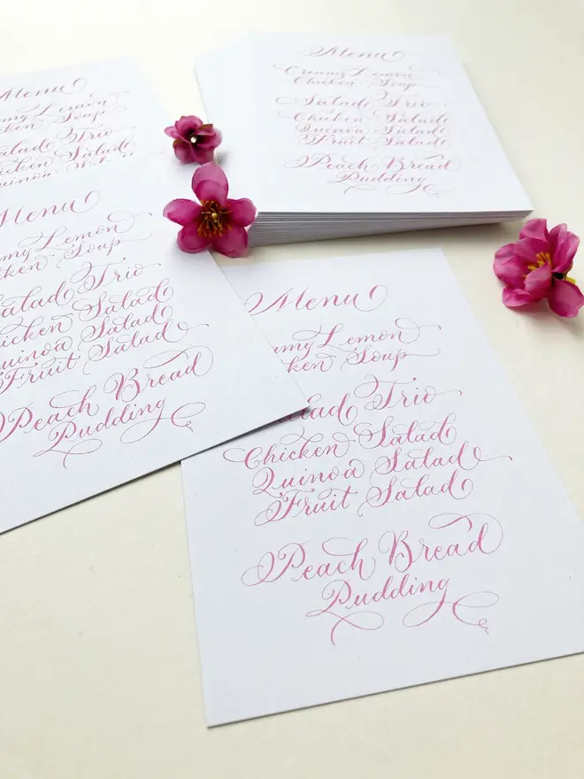 calligraphy wedding menus. white menu with pink calligraphy.