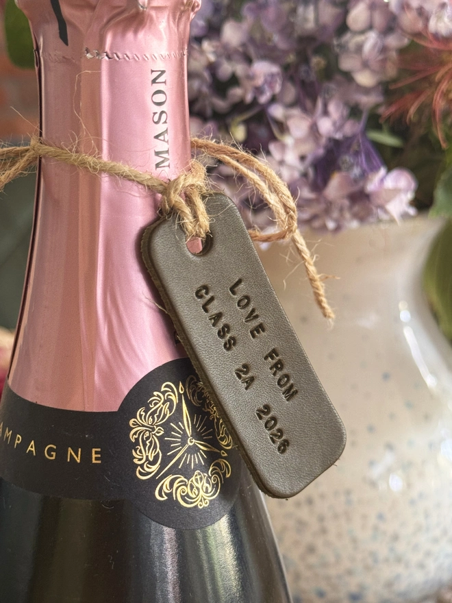 Olive green leather teacher label on a bottle of champagne