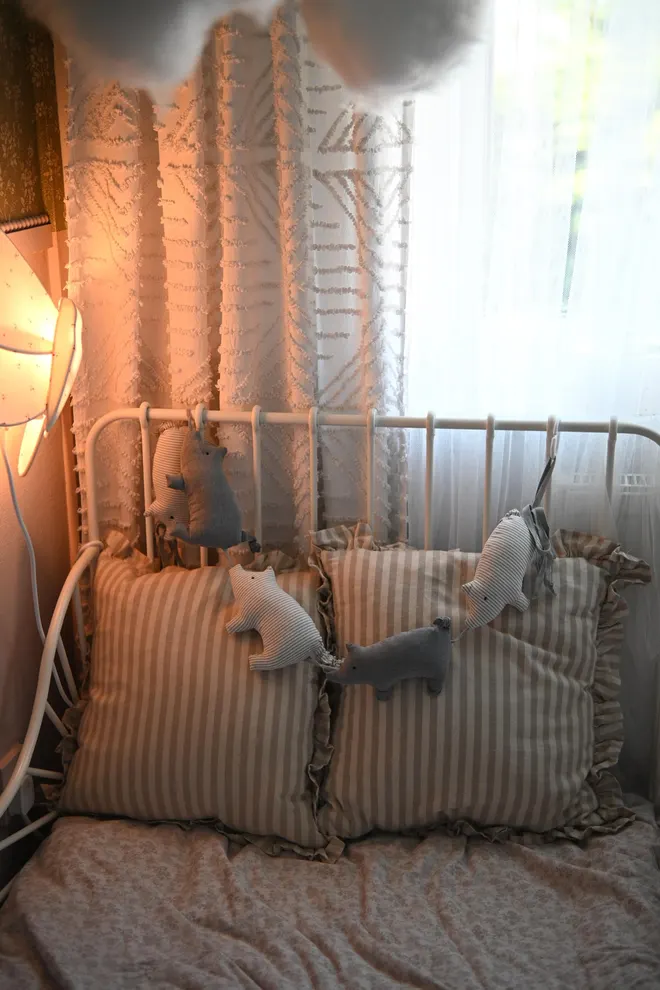 Pig Garland Decoration, a grey and white pig garland decoration in a child's bedroom. It is accompanied by other bedroom accessories. 