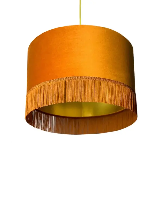 Rust Velvet Lampshade With Gold Lining & Fringing, against a white background. 