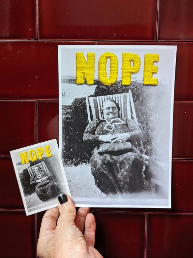  Photo of embroidered “Nope” B&W image of woman shown with giclee print version