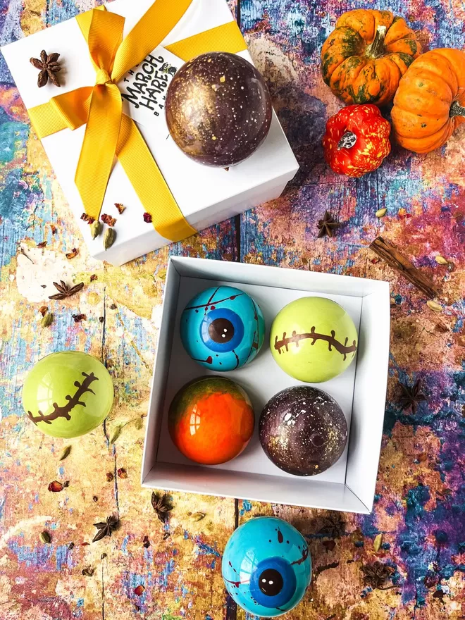 four halloween chocolate balls in a gift box
