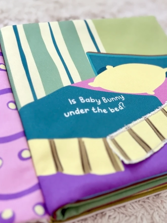 Page of Where's Baby Bunny? Lift-the-flap Cotton Soft Book, showing a bed and bedding to lift