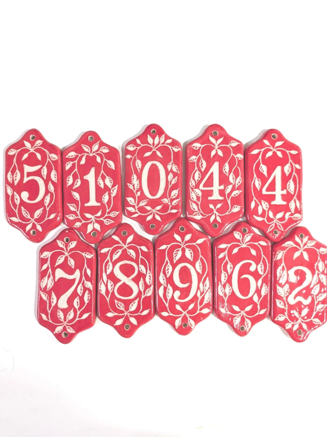 Red Sgraffito Leaf Address Tile. A selection of red tiles.