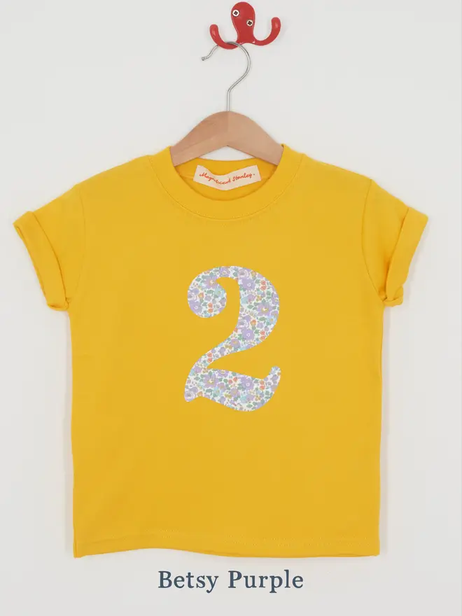 a yellow t-shirt with a Liberty floral print number 2 on front