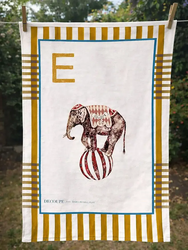 a-z alphabet tea towel. a tea towel with an elephant print and the letter 'e' in the corner.