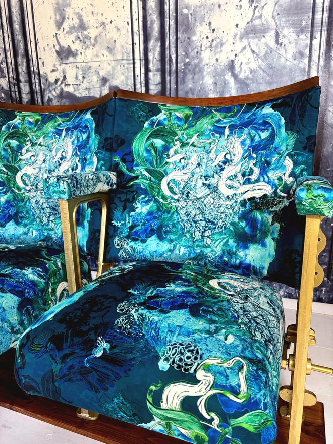 Close up image of the blue green velvet on a set of vintage cinema seats