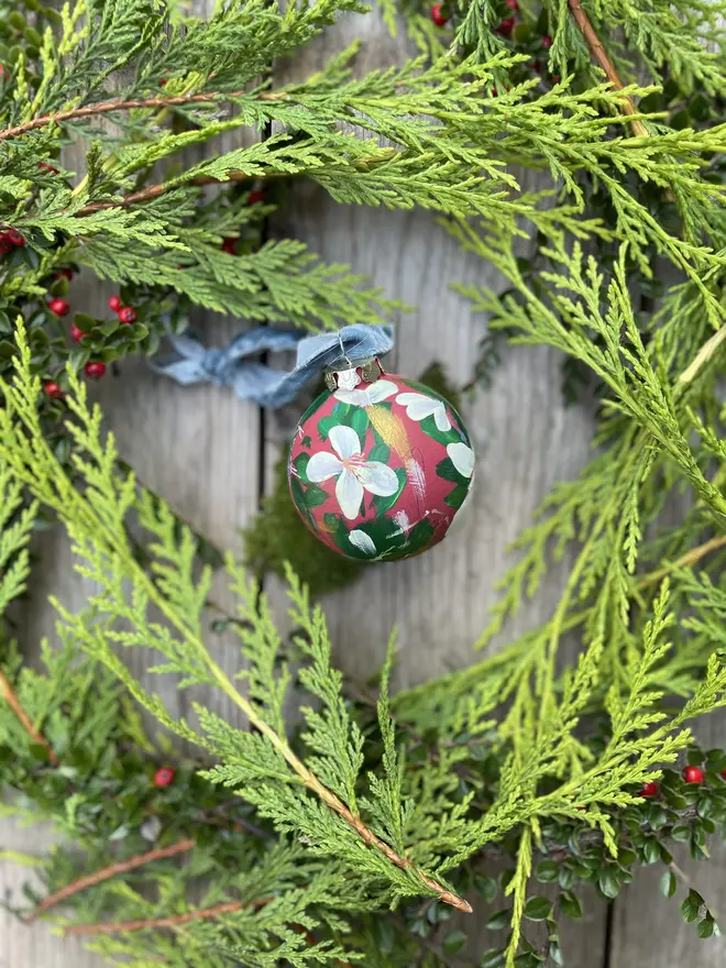 a set of six hand vibrant painted floral ceramic baubles all painted with an array of winter florals each finished with a luxurious velvet ribbon 