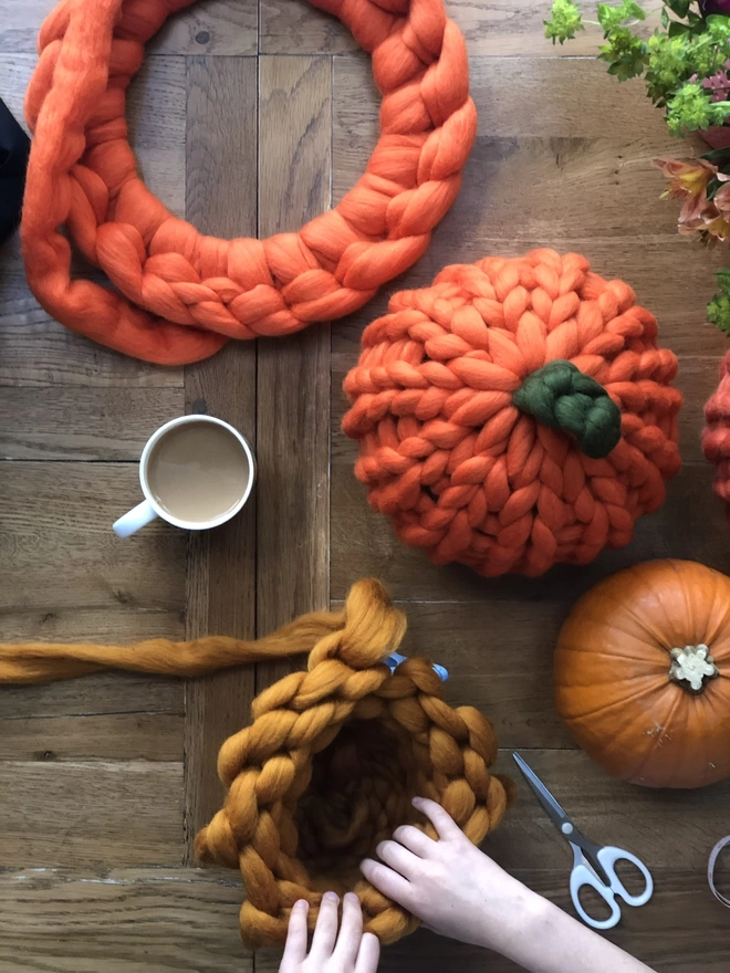 Image of the process making a knitted pumpkin.