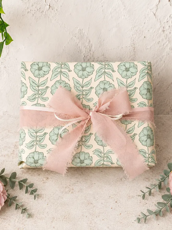personalised ceramic place name hearts. green floral gift wrap with pink ribbon.