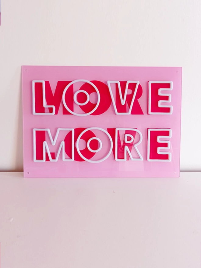 'love more more love' neon sign