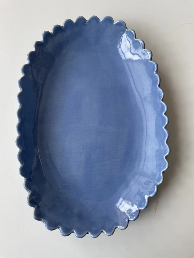 periwinkle blue oval serving bowl with organic scalloped edge