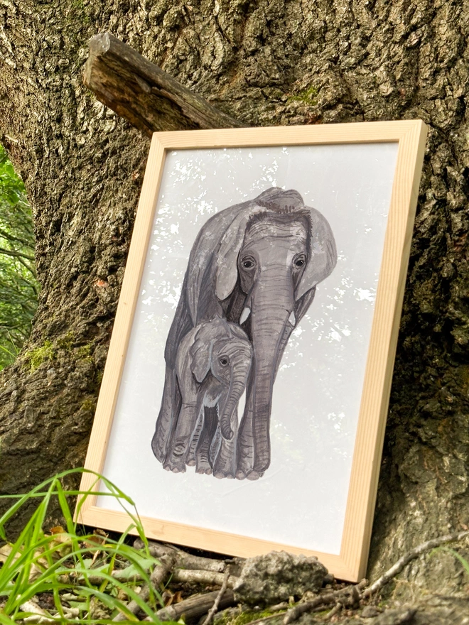a print featuring an illustration of a mother elephant with her calf