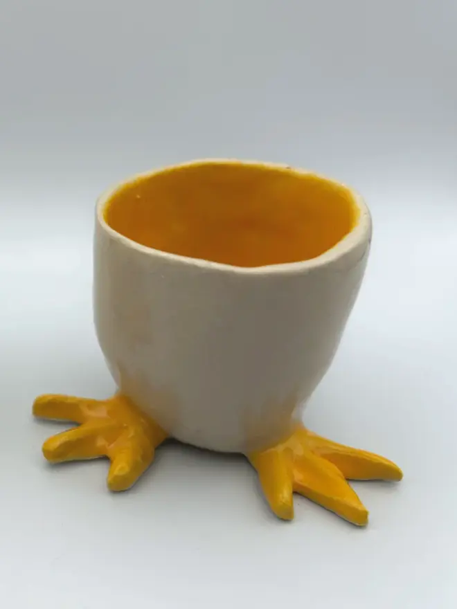 egg cup with yellow feet,