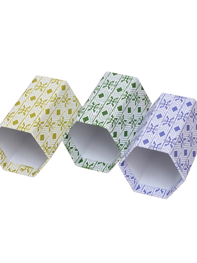 Tijan Hexagonal Brush Pot, a group of colourful pencil pots sitting on a white backdrop. 