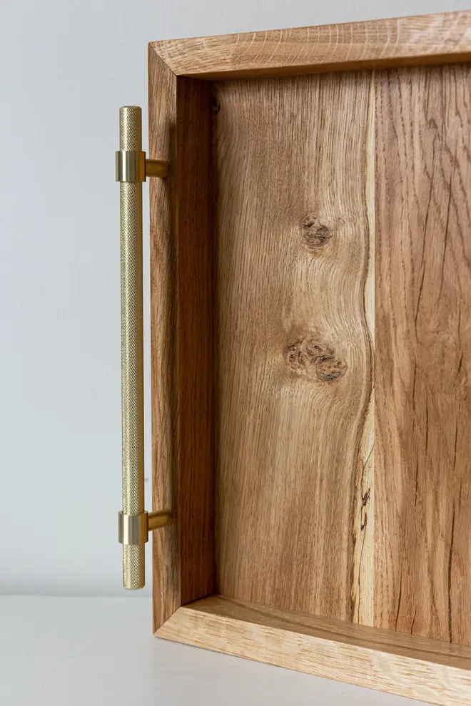 Oak and Brass Serving Tray, a wooden serving tray sat on a plain surface against a white backdrop. 