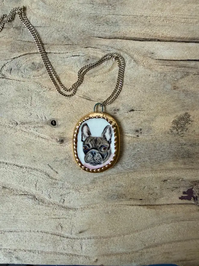 custom pet portrait pendant miniatures. a miniature painted dog portrait in a pendant frame.