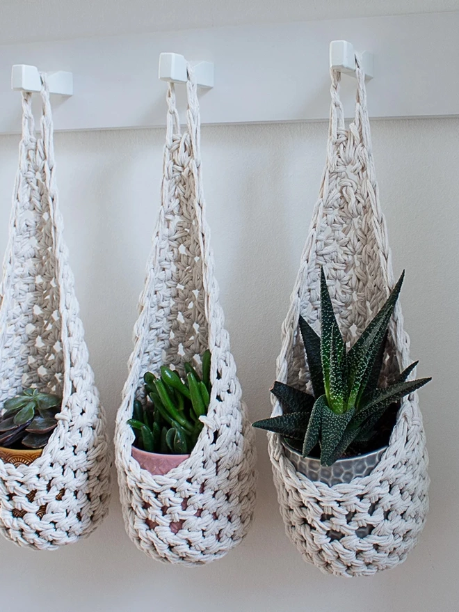 white indoor hanging wall planter plant basket handmade porch decor crochet boho eco friendly natural plant styling wall pot holder out door decor, indoor small white cotton hanging wall planter, white fabric wall mounted plant holder, handmade crochet plant basket, handmade sustainable crochet decor, rustic natural organic homeware accessories, hanging plant pot holder