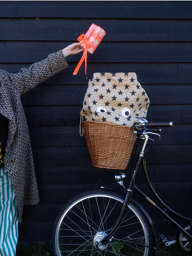 Googly eyes on star gift sack in bike basket