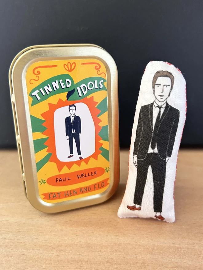 Mini fabric doll featuring illustration of Paul Weller in a gold tin.