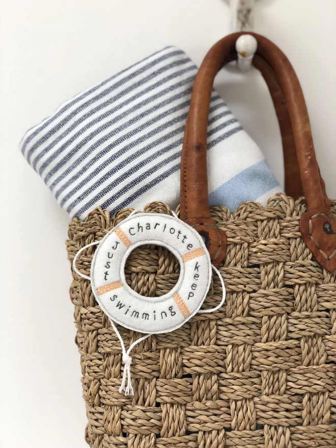 Just Keep Swimming Personalised Life Saver Ring on a bag with a towel