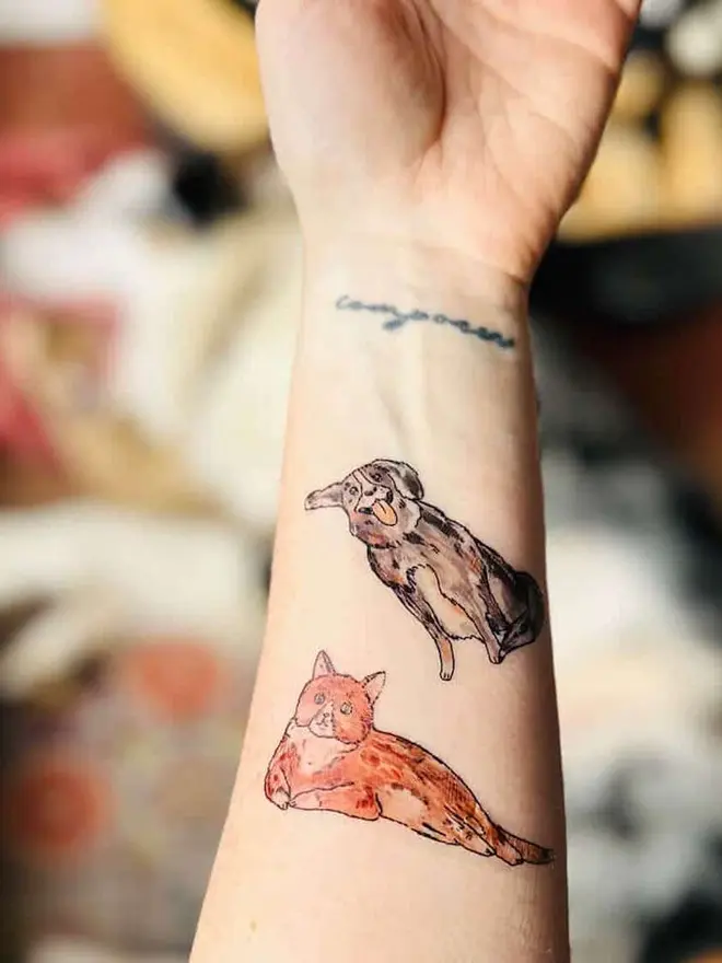 Pets Temporary Tattoos, an arm showing temporary tattoos of a sitting dog and a lying orange cat.