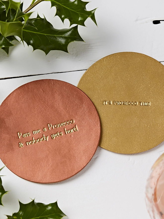 Copper and Gold leather coasters with large and small fonts.