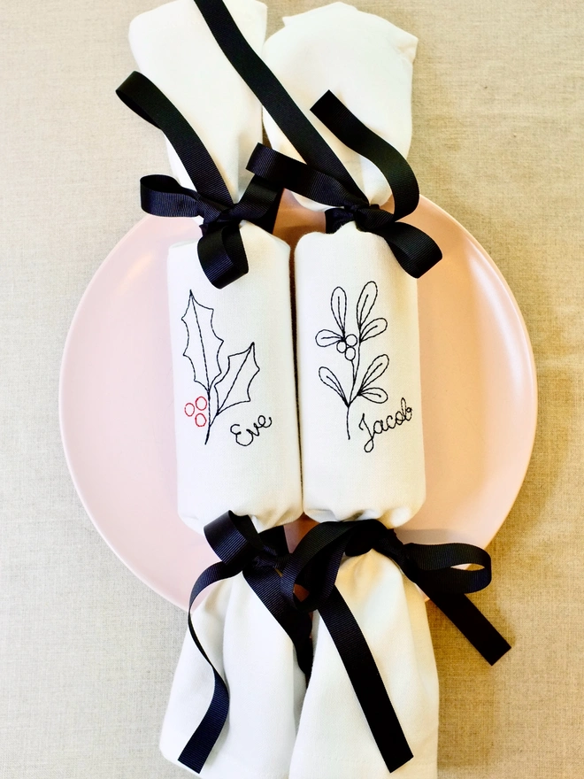 Personalised embroidered fabric Christmas cracker napkins holly and mistletoe and black ribbon bows
