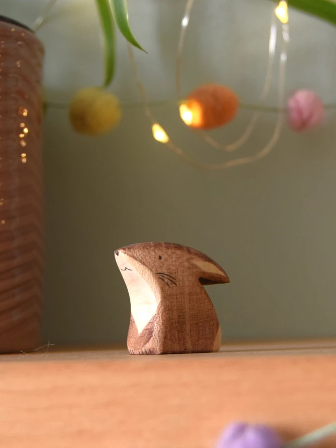 wooden brown baby kit rabbit peering up made by eric and alberts