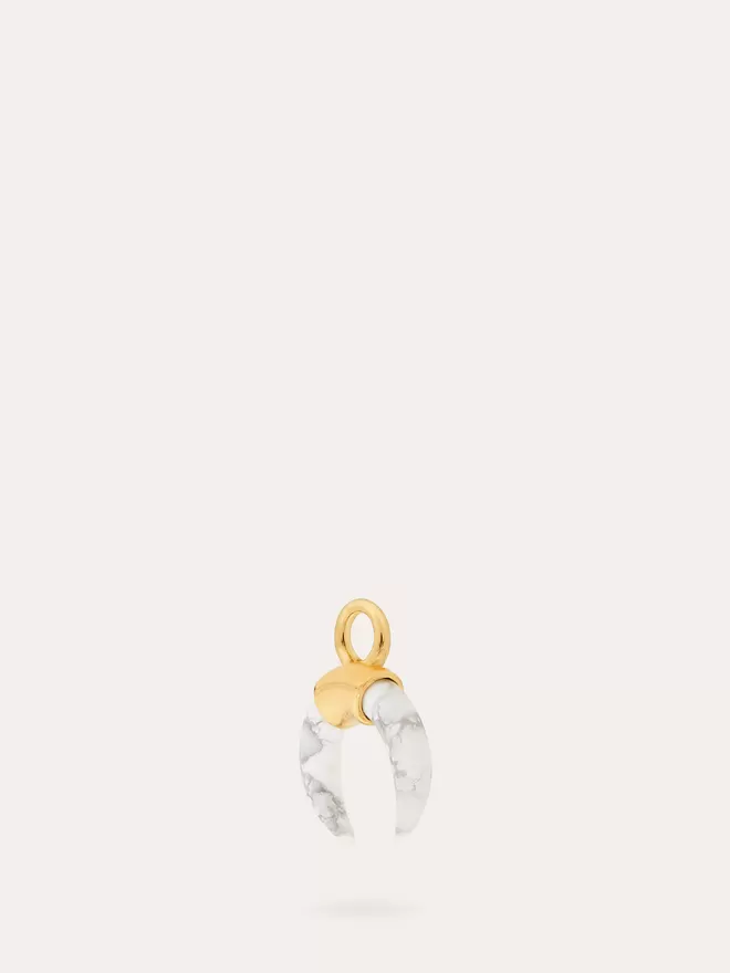 side view of a natural Howlite Horn gold Charm