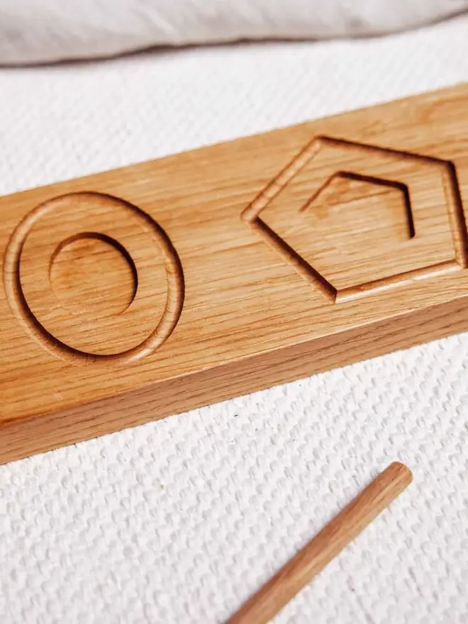 Wooden Shape Tracing Puzzle Heirloom Toy, on a table. 