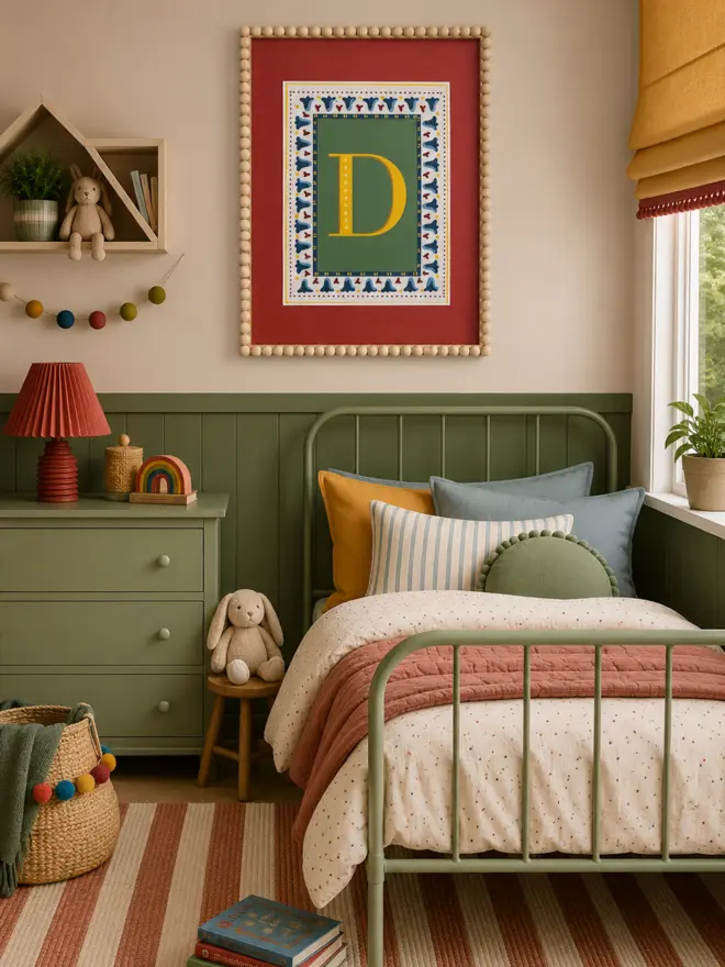 Vintage circus letter D art print in a wooden bead frame, featuring bold mustard yellow typography on a green background with decorative folk art motifs and a terracotta red border, styled in a colourful retro children’s bedroom.