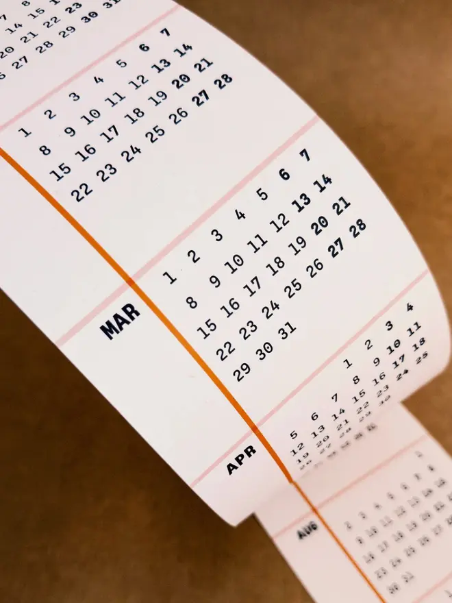 Yearly overview of the back of Squared: 2027 Monthly Wall Calendar, on a table. 