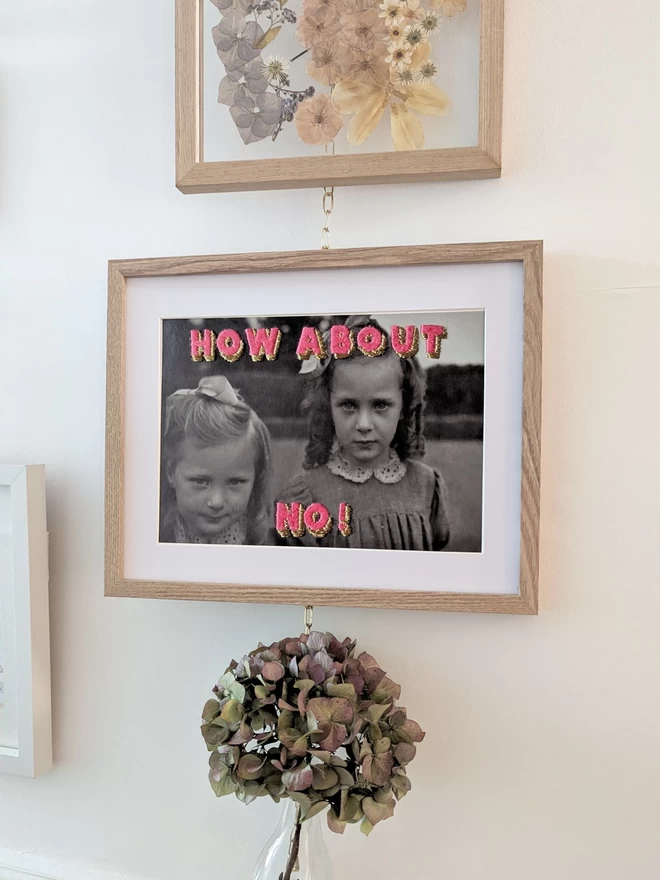B&W photo print of 2 girls with embroidered pink and Gold lettering, How about No! in frame