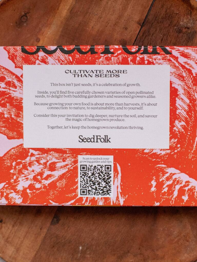 the salad bowl seed collection. back of box in pink and red packaging with illustrated tomatoes photographed on wooden surface.