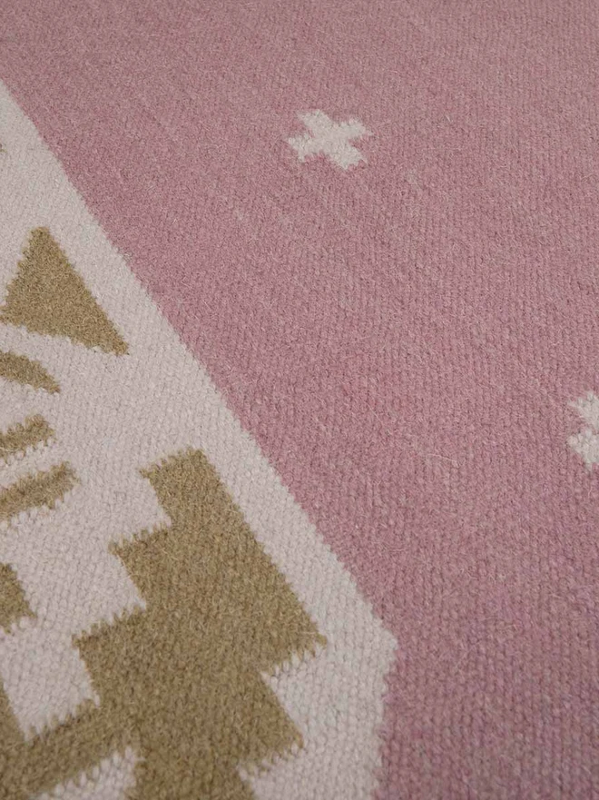 Manali Flatweave Rug, a colourful rug sitting on a plain surface. 