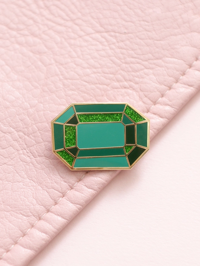 emerald enamel pink badge on pink leather jacket