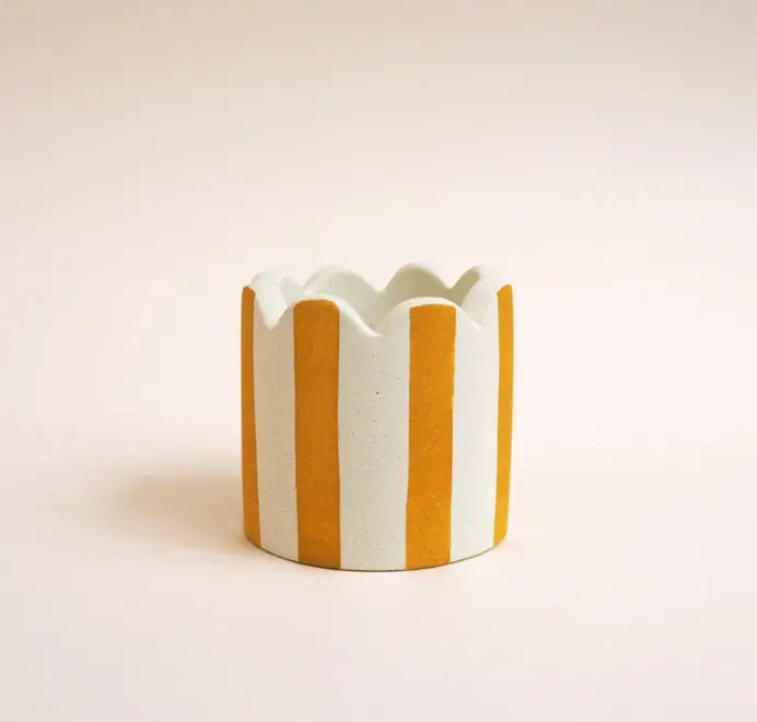 Small Scalloped Stripy Plant Pot. white ceramic pot with vertical coloured stripes set against a plain light background.