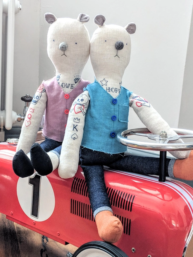 tattooed bear doll. two cream linen bear dolls with embroidered arm and neck tattoos and a blue or pink waistcoat.