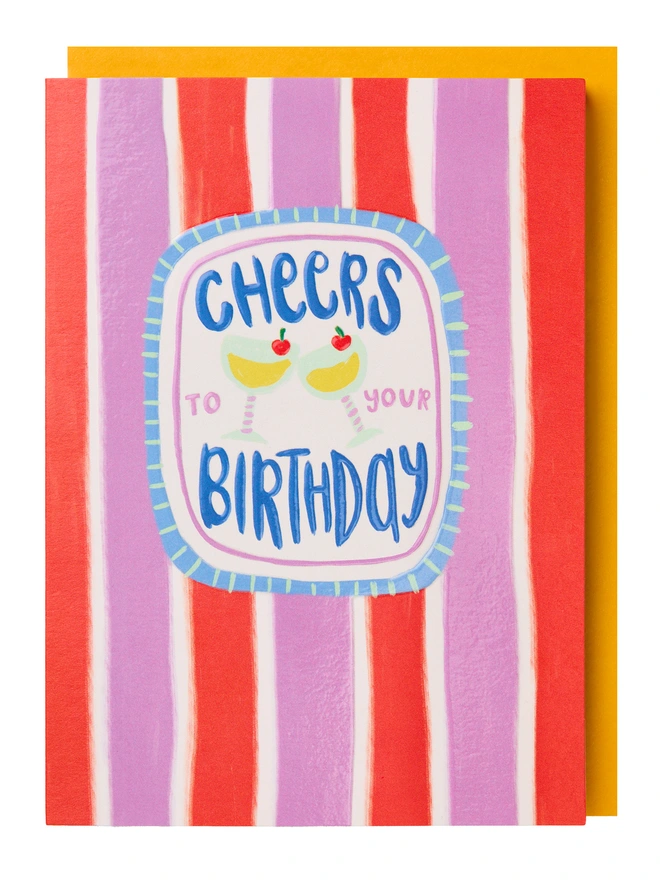 A colourful greeting card featuring two cocktails and the text 'Cheers to your birthday' with a purple and red striped background