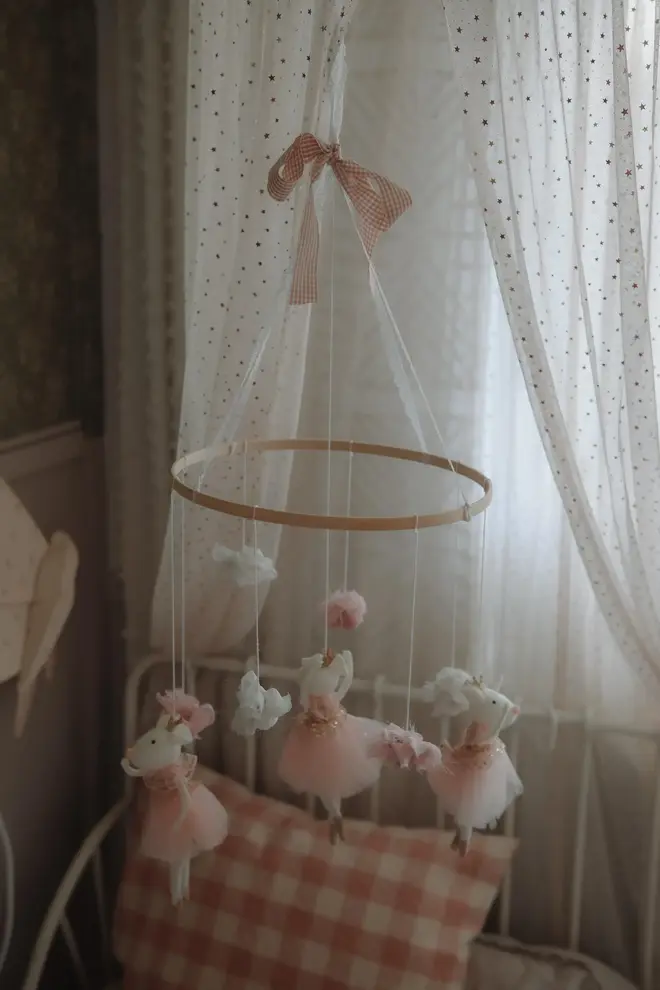 Hanging Mice Ballerina Felt Carousel Decoration, a hanging mice carousel decoration suspended in a child's decorated bedroom. 