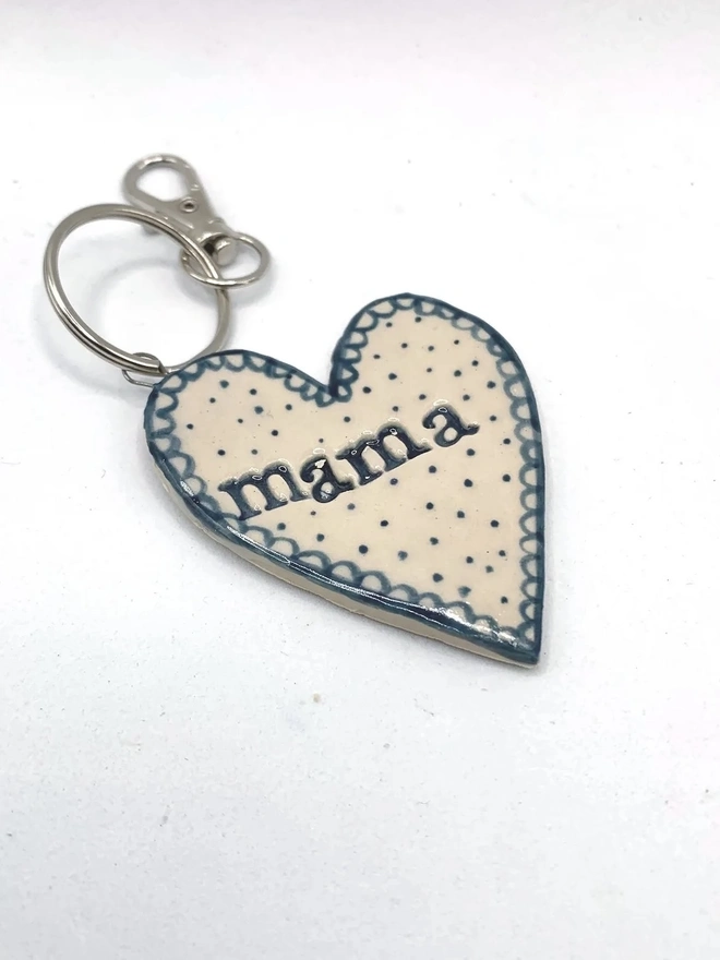 Mama Heart Ceramic Keyring, a blue keyring sitting on a plain white surface. 