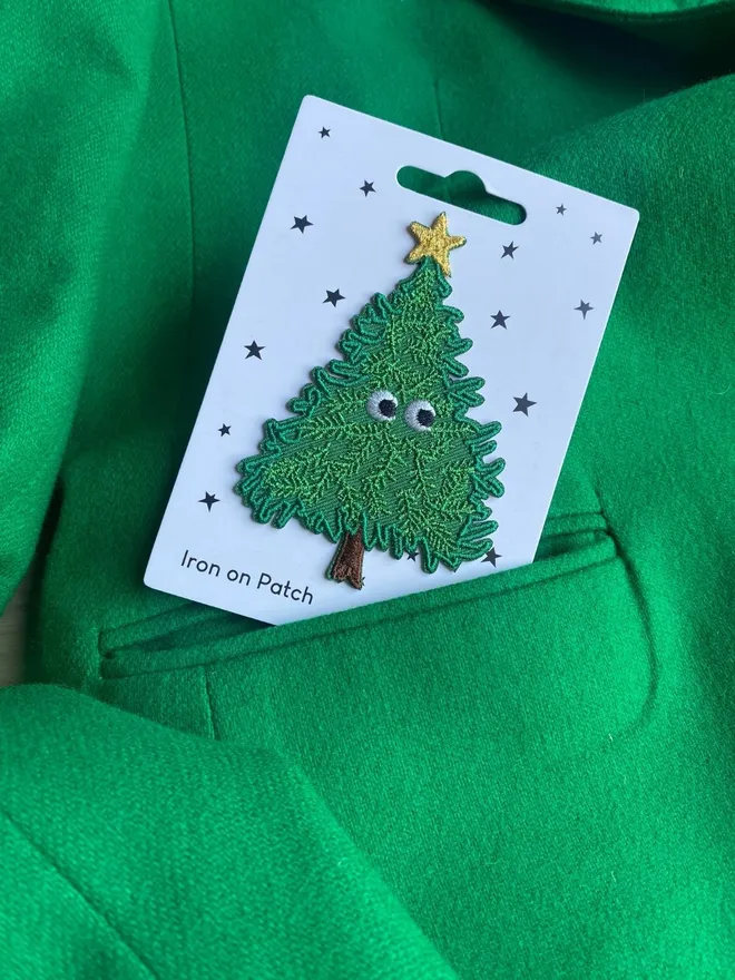 Christmas tree iron on patch with googly eyes.
