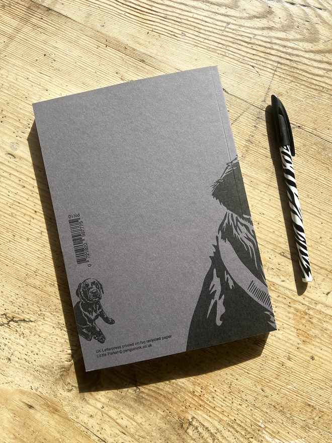 Back of the cockapoo notebook with a Lab puppy sat in the bottom left hand corner.